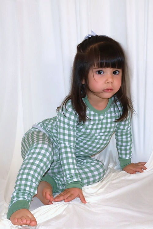 Child wearing the Goodnight Goose green gingham bamboo two-piece pajama set.