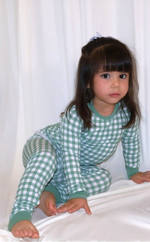 Child wearing Goodnight Goose green gingham bamboo two-piece pajamas