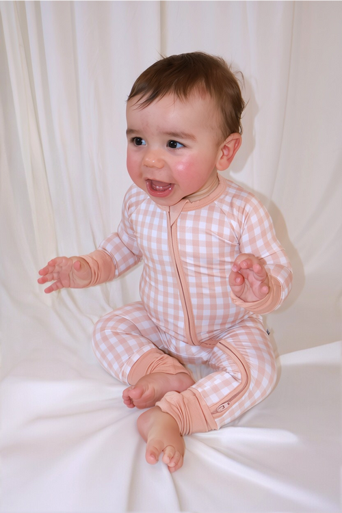 Baby wearing Goodnight Goose peach gingham bamboo zipper romper with two-way zipper