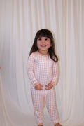 Toddler wearing Goodnight Goose peach gingham two-piece bamboo pajama set