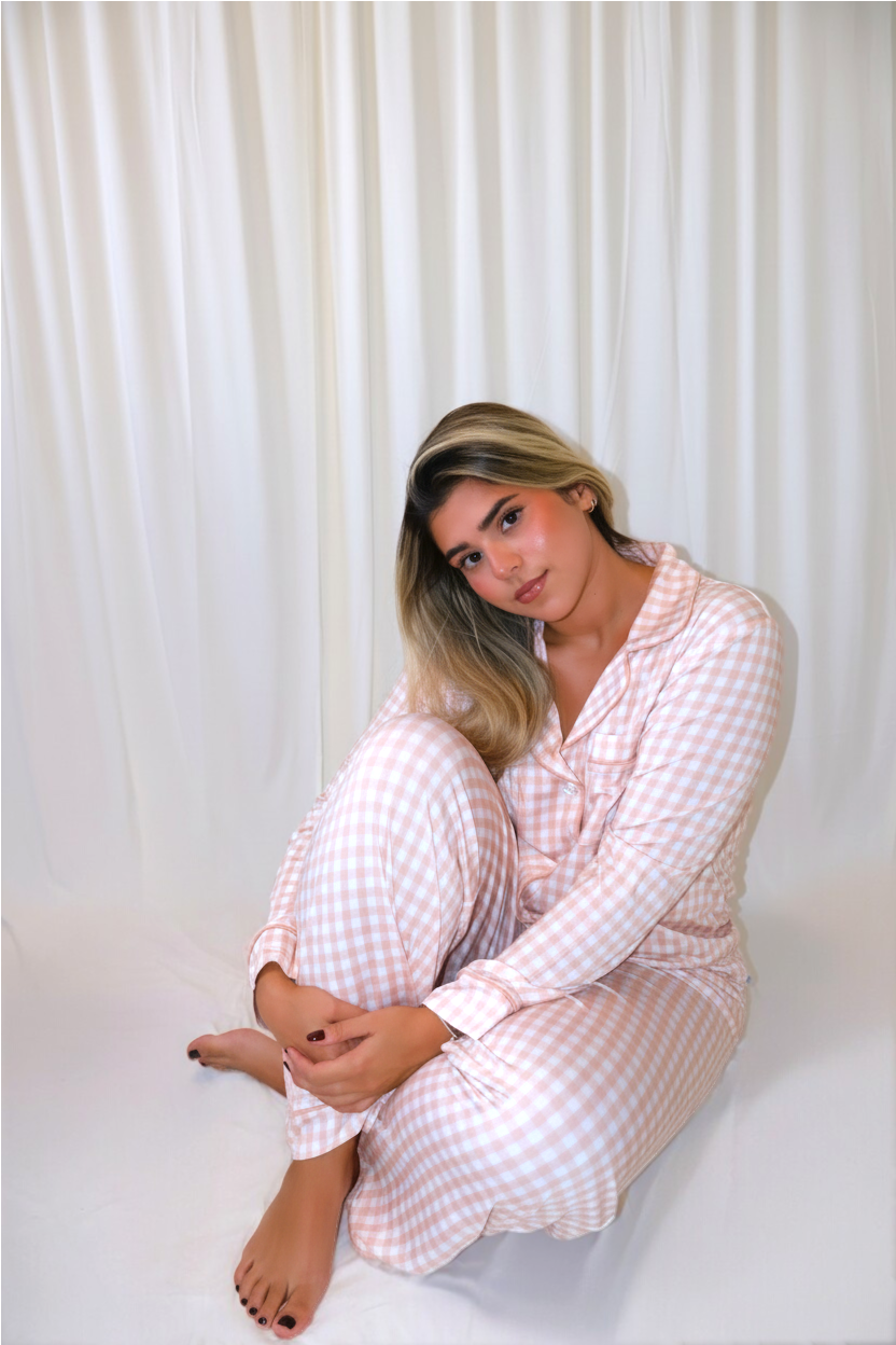 Woman wearing the Goodnight Goose peach gingham women's bamboo pajama set in a lifestyle photo.